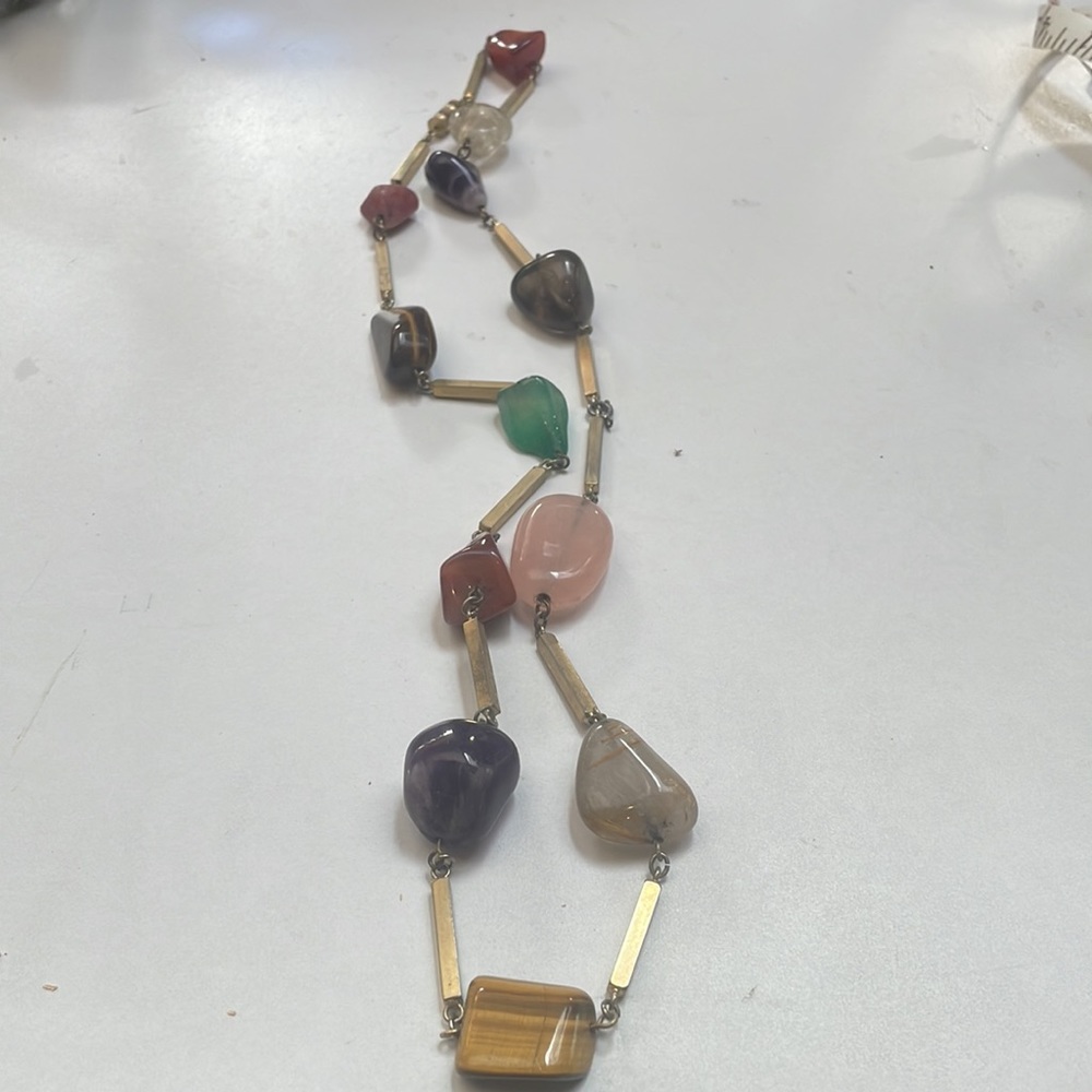 Polished beautiful stones, separated by gold, half inch lenders